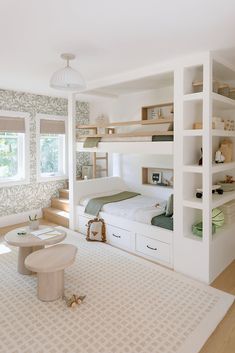 a bedroom with bunk beds and built - in shelving units on either side of the bed