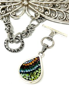 Get ready to be captivated by the Mosaic Swarovski Crystal Beaded Dangle Pendant - a true work of art for those who love luxury. Step up your fashion game with this necklace, which is ideal for showing off your impeccable flair and savoring every moment. Features of this Beaded Pendant Measures 2.5" length Chain sold separately includes Circular Toggle Attaches to any Stainless Steel chain you choose Hypo-Allergenic Non-Tarnishing Durable What was used to create this Beaded Pendant Antique Pewte Elegant Multicolor Metal Beaded Necklaces, Multicolor Necklaces With Detachable Pendant, Elegant Multicolor Crystal Beaded Necklaces, Elegant Multicolor Beaded Dangle Necklaces, Elegant Multicolor Teardrop Beaded Necklaces, Elegant Multicolor Drop Necklace As A Gift, Elegant Multicolor Drop Necklace For Gift, Multicolor Crystal Pendant Jewelry, Multicolor Crystal Teardrop Jewelry