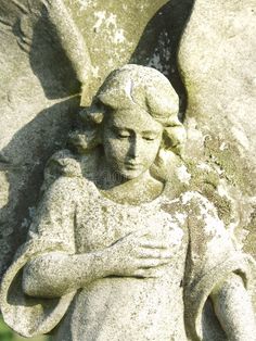 an angel statue with its arms crossed