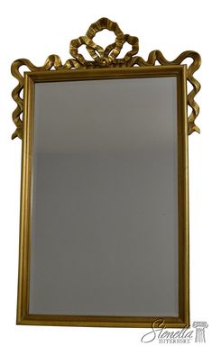 an ornate gold framed mirror against a white background