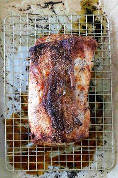 a piece of meat sitting on top of a metal rack