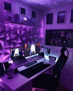 a computer desk with two monitors and a keyboard in front of a purple wall that has pictures on it