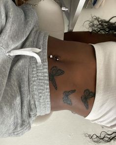 a woman with tattoos on her stomach