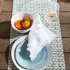 a bowl of oranges sitting on top of a table