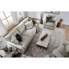 an aerial view of a living room with two couches and a coffee table in the middle