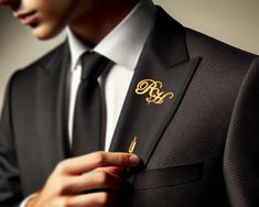 a man wearing a suit and tie with a monogrammed pocket square on his lapel