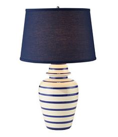 a blue and white striped lamp with a black shade