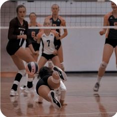 a group of women playing volleyball on a court