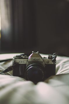 a camera sitting on top of a bed