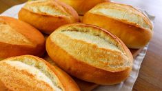 several loaves of bread sitting on top of a wooden table