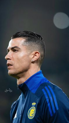 a soccer player is looking off into the distance with his head turned to the side