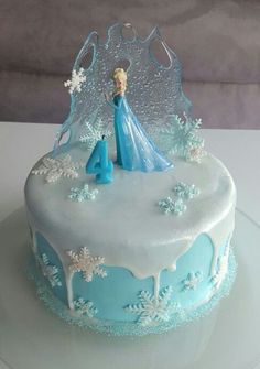 a frozen princess birthday cake with frosting and icing on the top is decorated with snowflakes