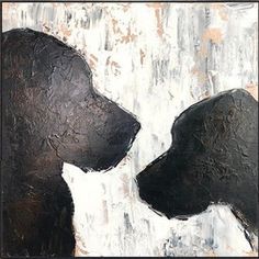 two black dogs standing next to each other in front of a white and gray wall