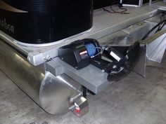 the front end of a boat being worked on by a machine that is attached to it