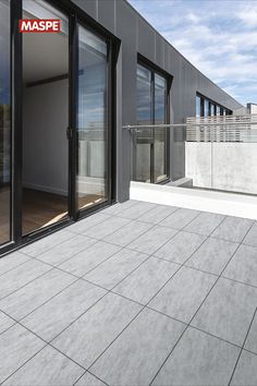 an empty balcony with sliding glass doors