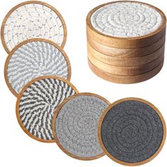 four coasters with different patterns on them and one has a wooden box in the middle