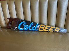 the word cold beer is cut into letters