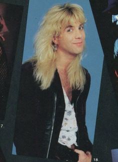 a man with long blonde hair wearing a black jacket