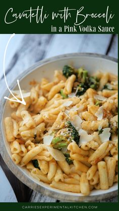 pasta with broccoli and cheese in a pink vodka sauce on a wooden table