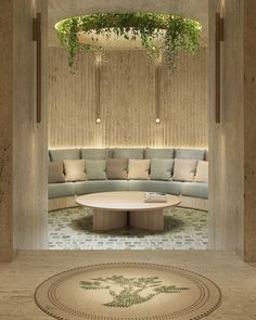 a living room filled with lots of furniture and plants hanging from the ceiling above it