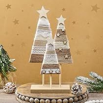 three wooden christmas trees sitting on top of a table