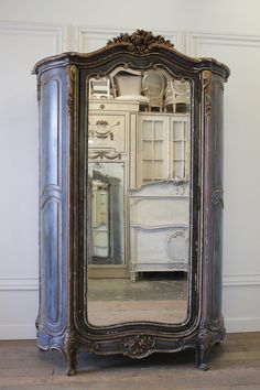 an ornate armoire with a mirror on it