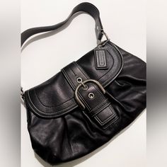 Coach Soho Pleated Buckle Should Bag With Front Flap! - Good Used Condition. - Material: Genuine Leather (Very Buttery And Supple!) - Color: Black With Subtle Metallic Finish (See Video) And Silver Hardware Why Am I Selling This Bag? The Quality Is Amazing, But I Haven't Reached For It In Years. It Is Difficult To Find Such Good Quality Bags These Days, So I've Hesitated To Let This One Go. The Leather Is So Supple, Metal Is Nicely Weighted, And The Inside Is Quite Generous And Can Hold More Than You'd Think! I'm Sad This Bag Is No Longer My Style. It Would Be A Perfect Casual Everyday Bag. Please Note There Are A Few Marks Throughout The Inside Of The Bag. They May Come Long I, Everyday Bag, Casual Everyday, Silver Hardware, Soho, Coach Bags, Black Silver, Black Color, Genuine Leather