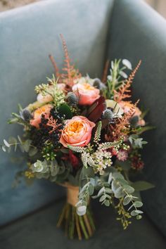 a bouquet of flowers sitting on top of a blue chair