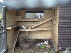 the inside of a barn with some animals in it