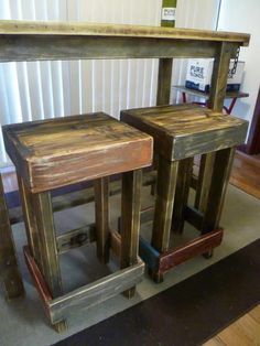 three wooden stools sitting next to each other on top of a carpeted floor