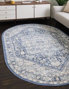 a blue and white area rug in a living room with furniture on the sidelines