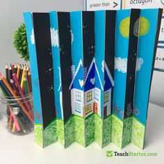 pencils are lined up in front of the back of skis with houses on them