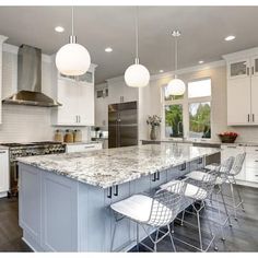 a large kitchen with an island and two chairs