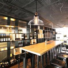 an empty bar with lots of bottles on the shelves