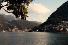 a body of water surrounded by mountains and houses