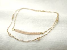 "Double strand beaded bar bracelet - dainty jewelry Tiny baby pink beads beaded on 14K gold filled chain. Double chain bracelet that's femininely dainty in soft shades of gold and blushing pink. measurements bead bar length 1\" please choose length at checkout ♦you can enter shop here! http://etsy.com/shop/illusy" Dainty Pink Beaded Chain Bracelet, Delicate Pink Beaded Chain Jewelry, Delicate Beaded Bracelets With Adjustable Chain, Dainty Rose Gold Beaded Bracelets, Dainty Double Strand Beaded Bracelets For Gift, Delicate Beaded Bracelets With Satellite Chain, Delicate Pink Beaded Bracelets For Everyday, Delicate Pink Beaded Bracelets, Delicate Pink Jewelry With Tiny Beads