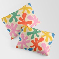 two pillows with colorful designs on them