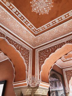 an intricately decorated ceiling in the middle of a building