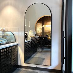 an arched mirror in the middle of a restaurant