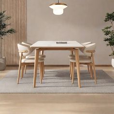 a dining room table with chairs and a potted plant on the floor next to it