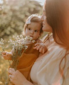 a woman holding a baby in her arms