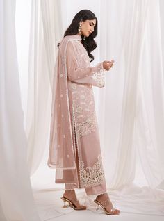 Indulge in the epitome of femininity with our enchanting light pink ensemble. perfectly allured with floral all over with exquisite thread work on the front, delicately intertwined motifs create a mesmerizing pattern that adds depth and allure. Paired seamlessly with matching pants, Completing the ensemble is a sheer net dupatta adorned with intricate white embroidery. Shirt: NetPants: Raw SilkDupatta: Net Elegant Pink Organza Sets, Feminine Chikankari Embroidery Sets For Wedding, Elegant Pink Dupatta With Intricate Embroidery, Elegant Pink Georgette Sets, Summer Pink Sets With Chikankari Embroidery, Elegant Pink Dupatta For Reception, Pink Organza Sets For Spring, Feminine Summer Sets With Chikankari Embroidery, Feminine Embroidered Sets For Eid