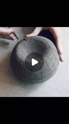 someone is making a large rock out of cement