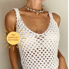 a woman wearing a white crochet tank top with a gold necklace on her neck