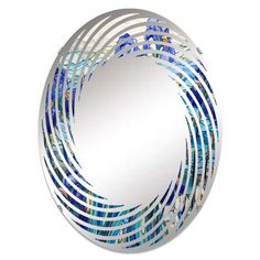 a round mirror with blue and white designs on it's sides, in front of a white background