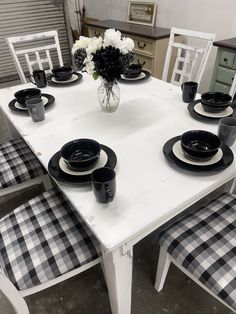 a white table topped with black and white plates