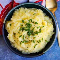 a bowl filled with mashed potatoes topped with chives