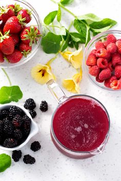 berries, raspberries and other fruits are in bowls