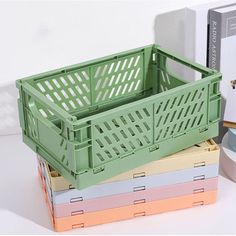 a stack of colorful boxes sitting next to each other on top of a white table