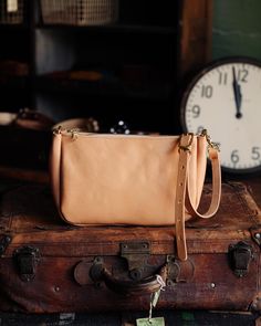 The classic KMM & Co. Crossbody Bag is a perfect everyday companion. Like the other members of the Crossbody Bag family, it's handmade in the USA of beautiful full-grain leather. It comes standard with a solid brass zipper to keep your belongings secure and solid brass D-rings to attach a crossbody or shoulder strap. Choose from a crossbody strap made in the same leather as your bag — like a vintage-inspired chain link strap, a super-adjustable slider strap, or a squishy two-ply strap — or go wi Vegetable Tanned Leather Crossbody Saddle Bag, Everyday Vegetable Tanned Leather Crossbody Saddle Bag, Vegetable-tanned Saddle Bag For Everyday Use, Crossbody Style, Classic Leather Tote, Leather Crossbody Bags, Custom Strap, Leather Tote Bags, Carryall Tote, Mini Bucket Bags